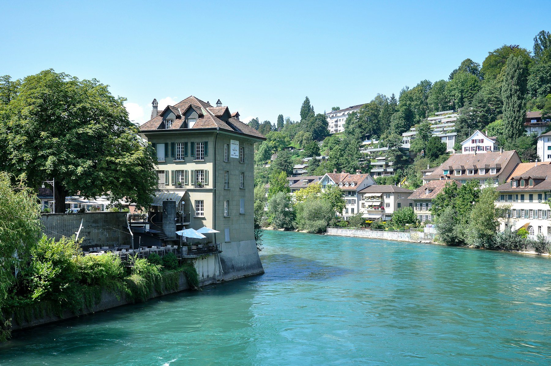 Historic Bern buildings beside the turquoise Aare River