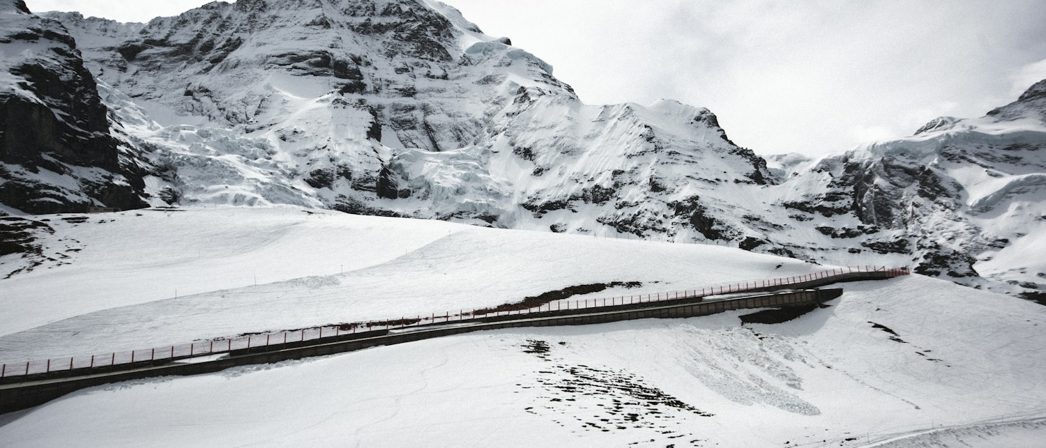 Snow-covered mountains and a train in the Jungfrau region